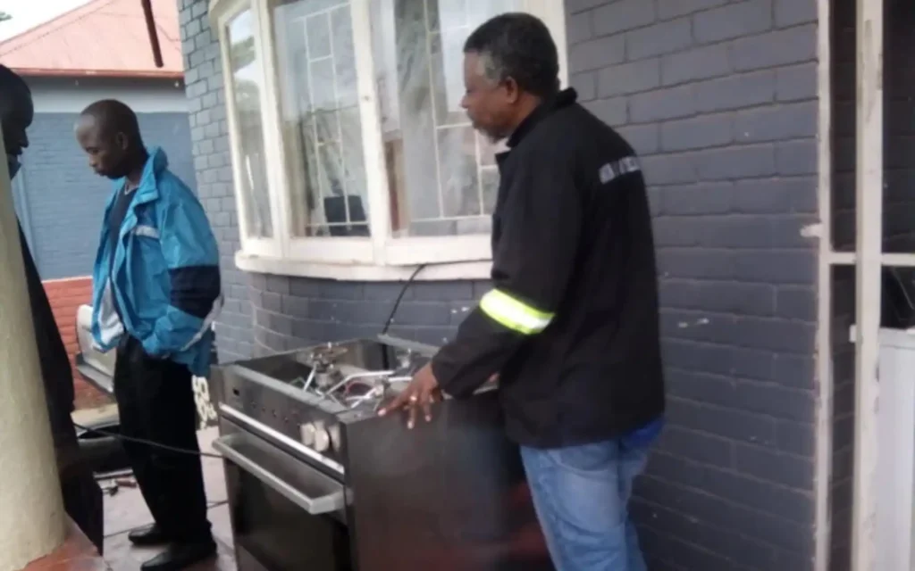 Cape Town appliance repair team discussing how to fix a faulty washing machine