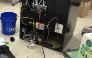 Technician repairing a refrigerator in a Cape Town home