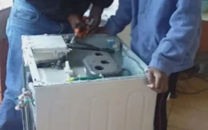 Technician team fixing a washing machine in Cape Town