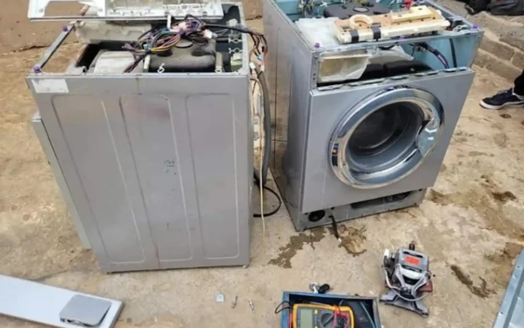 Appliance repair team working on multiple washing machines
